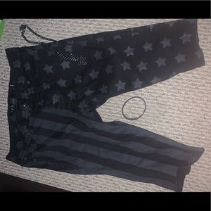 Black shorts, wrist band and necklace